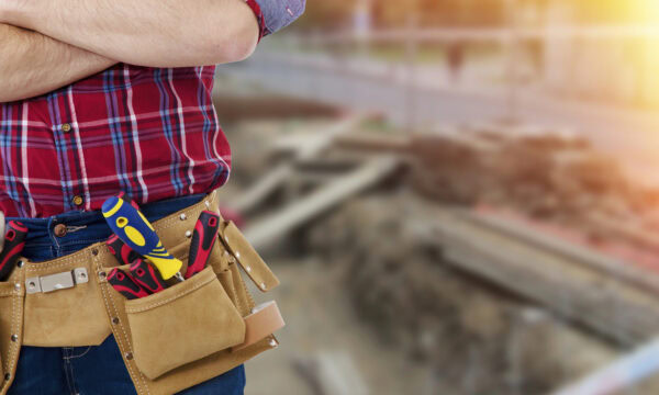 builder with the belt of tools on background to outdoor