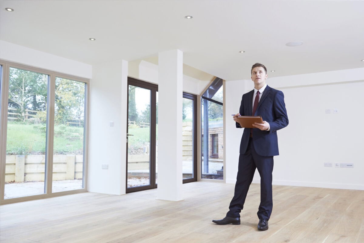 estate agent looking around the vacant house