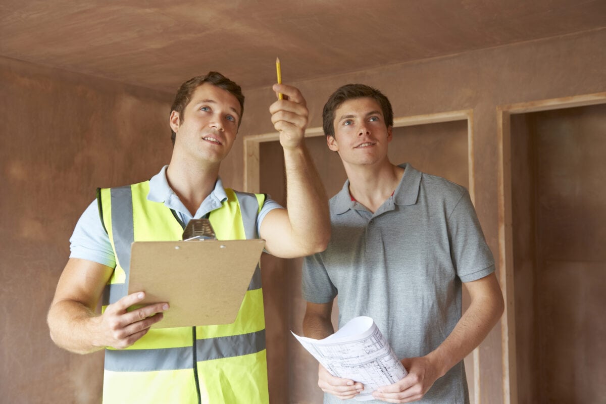 builder and inspector looking inside the house